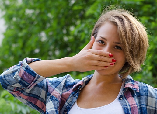 woman covering mouth with hand