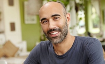 man in grey shirt smiling