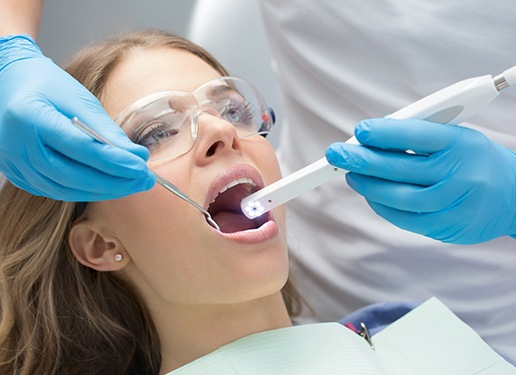 woman with intraoral camera in mouth